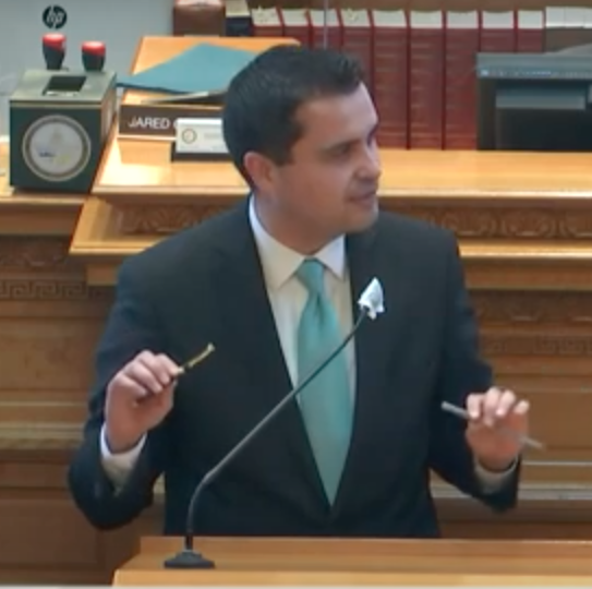 Rep Dave Williams with "veto" pen